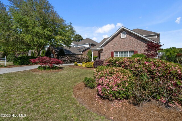 423 Black Diamond Dr, Wilmington, NC 28411 - view of front facade with a front lawn and brick siding