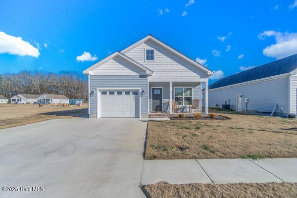 119 Bridgetowne Ave, Edenton, NC 27932 - view of front facade featuring a front yard, a porch, an attached garage, central air condition unit, and driveway