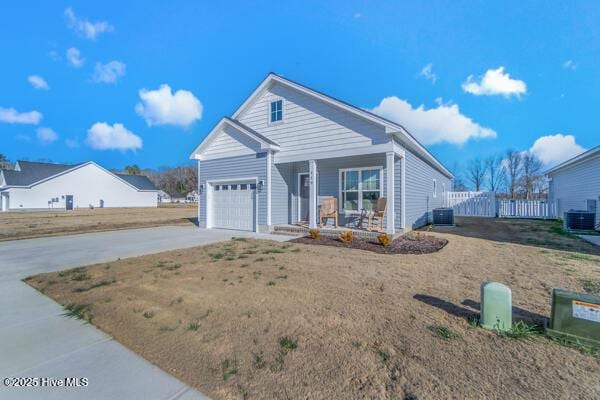 119 Bridgetowne Ave, Edenton, NC 27932 - view of front facade with central AC unit, covered porch, a garage, fence, and driveway