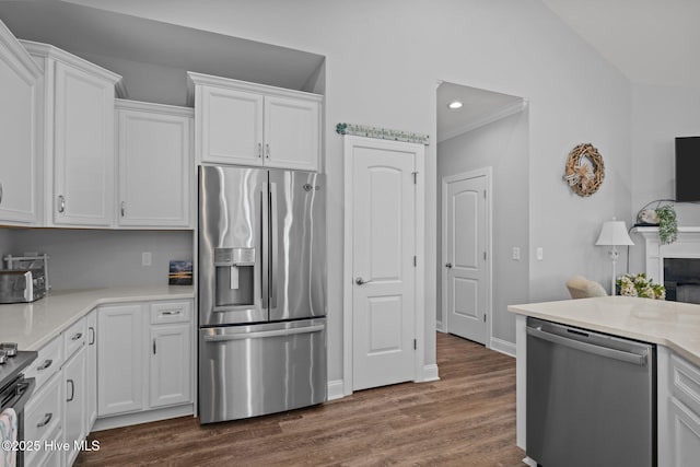 kitchen featuring stainless steel appliances, white cabinets, light countertops, and dark wood finished floors