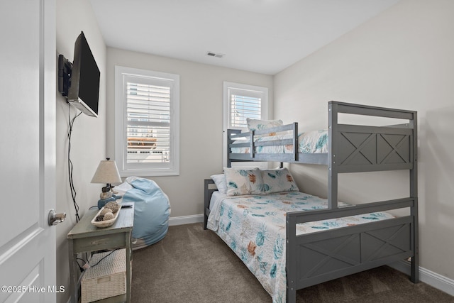 carpeted bedroom with visible vents and baseboards