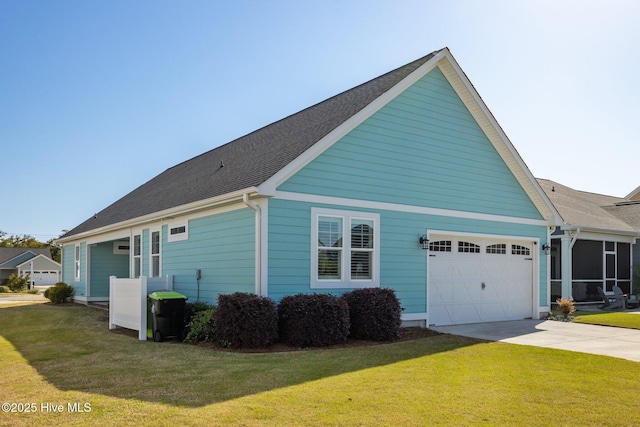 view of home's exterior featuring a garage, a yard, and driveway