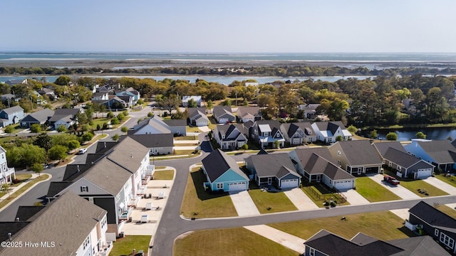 birds eye view of property with a water view and a residential view