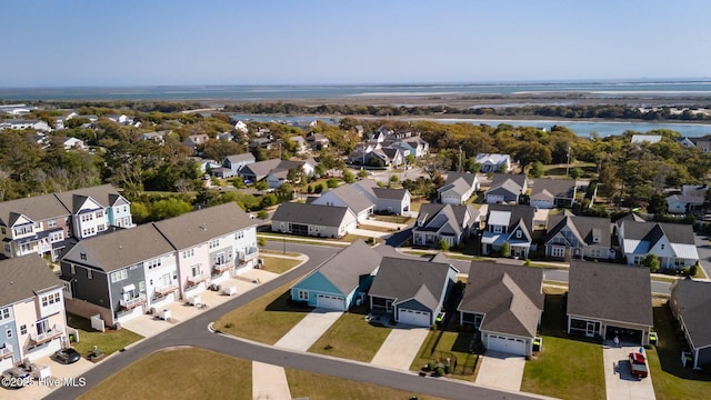 birds eye view of property with a water view and a residential view