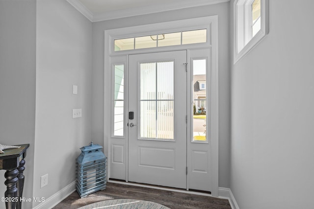 foyer entrance featuring dark wood-style floors, baseboards, and crown molding