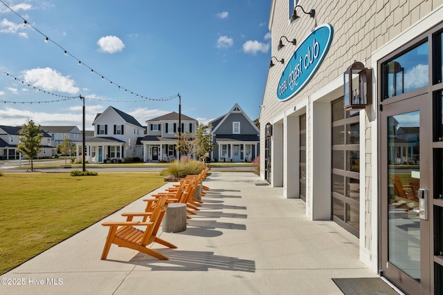 view of property's community with a residential view and a lawn