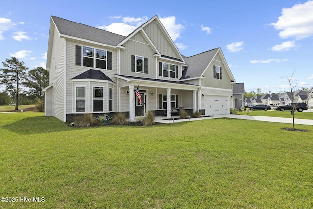 view of front of property featuring driveway, board and batten siding, a front yard, a garage, and covered porch