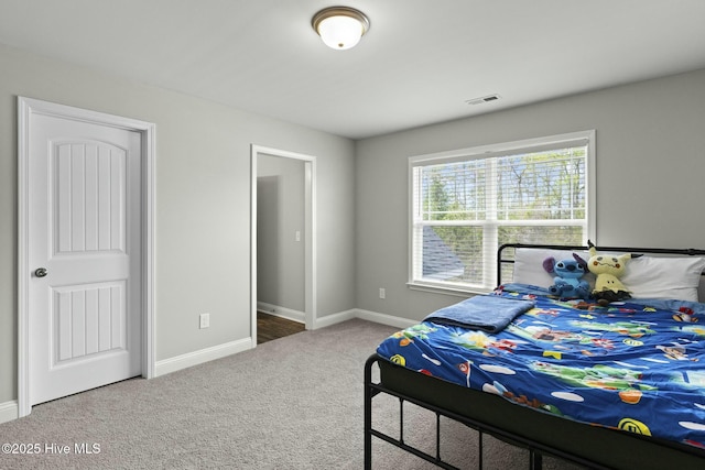carpeted bedroom featuring visible vents and baseboards