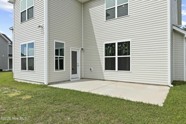 back of house with a patio and a yard