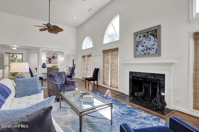 1957 Prestwick Ln, Wilmington, NC 28405 - living room with high vaulted ceiling, wood finished floors, ceiling fan, a fireplace, and baseboards