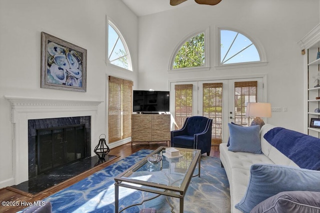 1957 Prestwick Ln, Wilmington, NC 28405 - living area with french doors, wood finished floors, a high ceiling, a high end fireplace, and ceiling fan