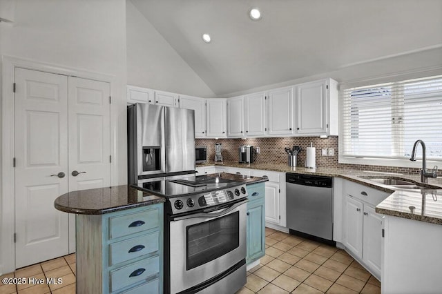 1957 Prestwick Ln, Wilmington, NC 28405 - kitchen with stainless steel appliances, a sink, white cabinets, lofted ceiling, and recessed lighting