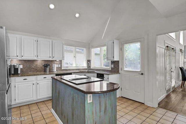1957 Prestwick Ln, Wilmington, NC 28405 - kitchen with a sink, black electric cooktop, light tile patterned floors, white cabinetry, and lofted ceiling