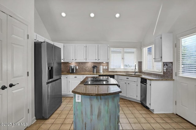 1957 Prestwick Ln, Wilmington, NC 28405 - kitchen featuring stainless steel refrigerator with ice dispenser, vaulted ceiling, a sink, a center island, and tasteful backsplash