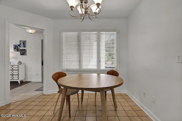 1957 Prestwick Ln, Wilmington, NC 28405 - dining space featuring light tile patterned floors, a chandelier, and baseboards