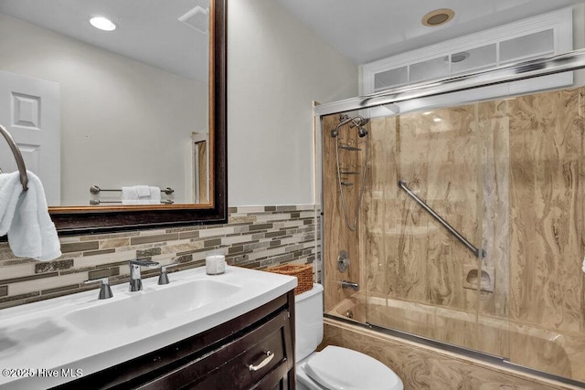 1957 Prestwick Ln, Wilmington, NC 28405 - full bath featuring vanity, toilet, bath / shower combo with glass door, and decorative backsplash