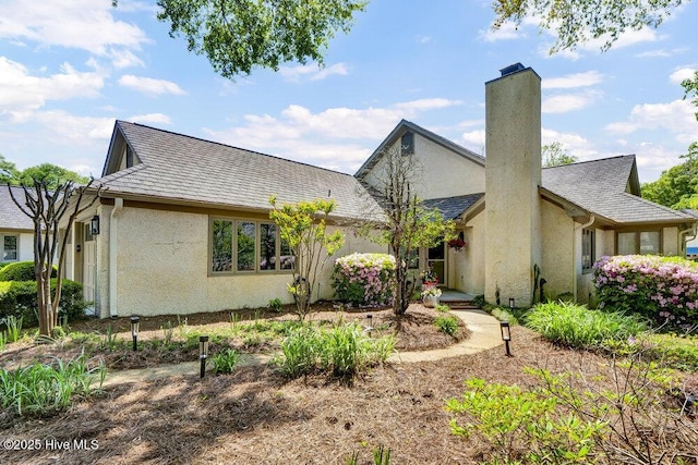 1957 Prestwick Ln, Wilmington, NC 28405 - view of front of house with stucco siding and a chimney