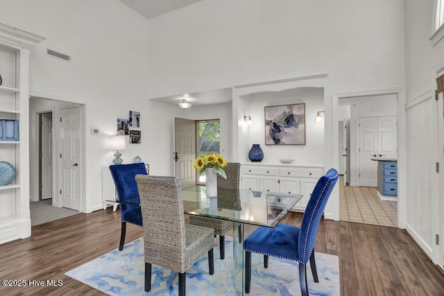 1957 Prestwick Ln, Wilmington, NC 28405 - dining room with a high ceiling, dark wood-style flooring, and baseboards