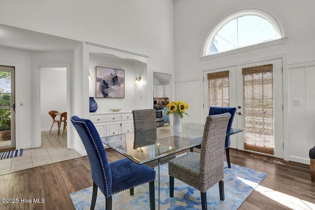1957 Prestwick Ln, Wilmington, NC 28405 - dining space with french doors, wood finished floors, and a towering ceiling