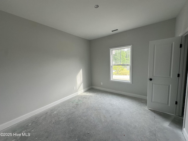 unfurnished room featuring baseboards and visible vents