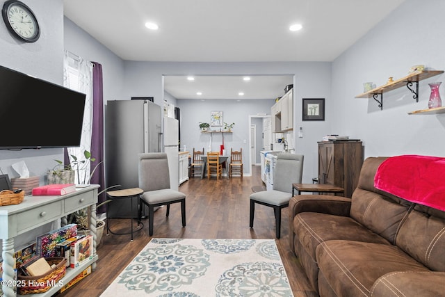 living room with recessed lighting and dark wood-style floors