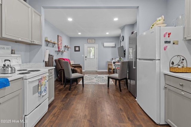 kitchen with open floor plan, light countertops, white appliances, and dark wood-style floors