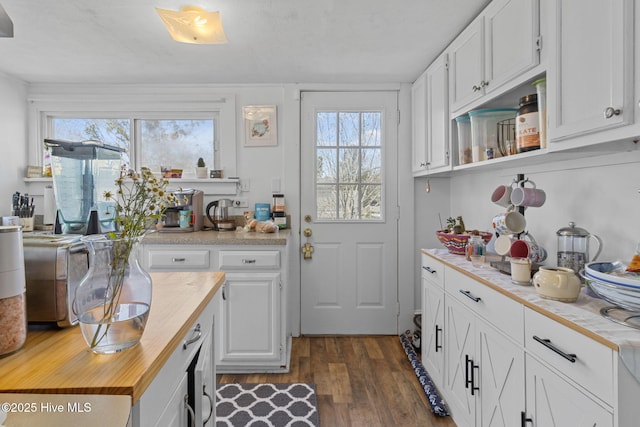 kitchen with white cabinetry, wood counters, and dark wood finished floors