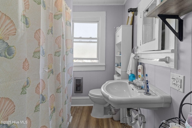 bathroom with curtained shower, visible vents, toilet, and wood finished floors