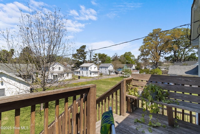 wooden terrace with a yard and a residential view