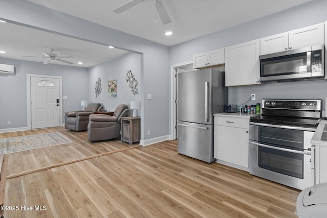 kitchen with stainless steel appliances, light wood finished floors, white cabinetry, and ceiling fan
