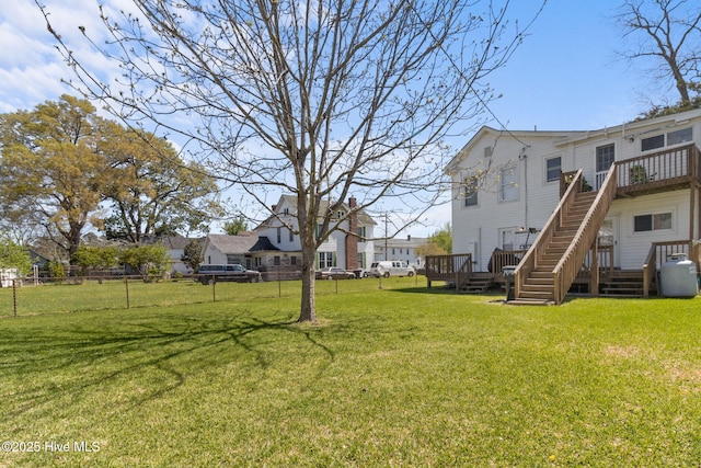 view of yard featuring a residential view, fence, and a deck