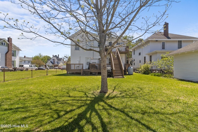 view of yard featuring fence, a residential view, and a wooden deck