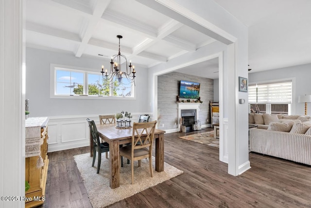 41 S Lamplighters Walk, Hampstead, NC 28443 - dining room featuring beamed ceiling, healthy amount of natural light, a fireplace with flush hearth, dark wood-style flooring, and a chandelier