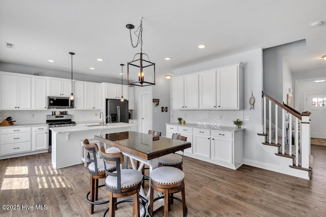 41 S Lamplighters Walk, Hampstead, NC 28443 - kitchen featuring stainless steel appliances, backsplash, wood finished floors, light countertops, and recessed lighting