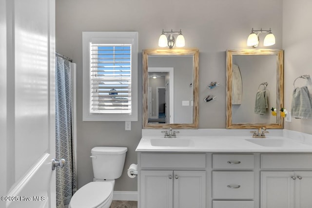 41 S Lamplighters Walk, Hampstead, NC 28443 - full bathroom with double vanity, toilet, baseboards, and a shower with curtain