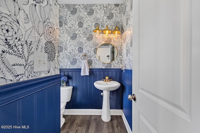 41 S Lamplighters Walk, Hampstead, NC 28443 - bathroom with wainscoting, toilet, wood finished floors, baseboards, and wallpapered walls