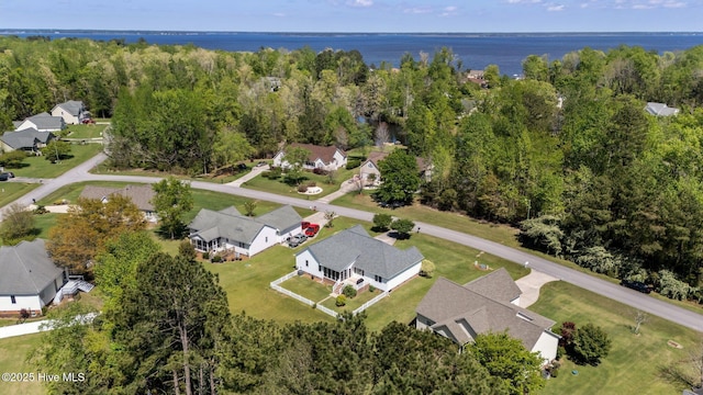 birds eye view of property featuring a wooded view and a residential view