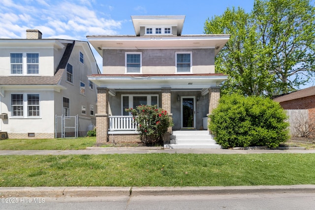 traditional style home featuring stucco siding, a chimney, a front yard, a porch, and fence