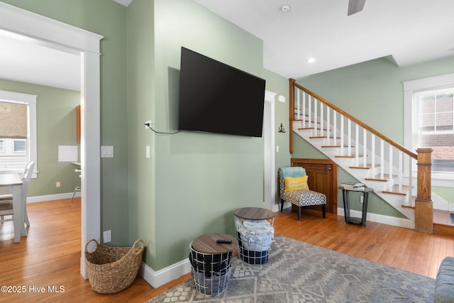 interior space featuring recessed lighting, baseboards, and wood finished floors