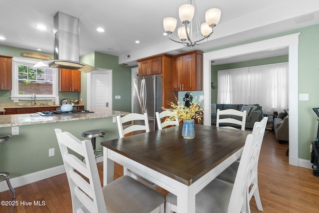 dining room featuring baseboards, a chandelier, recessed lighting, visible vents, and wood-type flooring