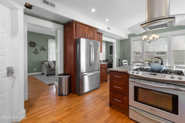 kitchen with stainless steel appliances, light wood-style flooring, visible vents, and island exhaust hood