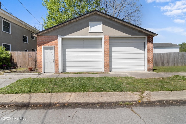 detached garage featuring fence