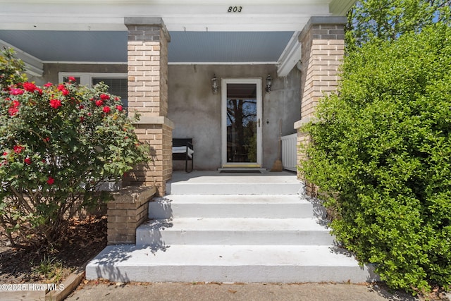 entrance to property featuring stucco siding