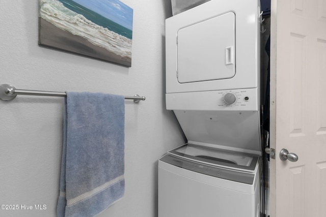 laundry area featuring stacked washer and dryer and laundry area