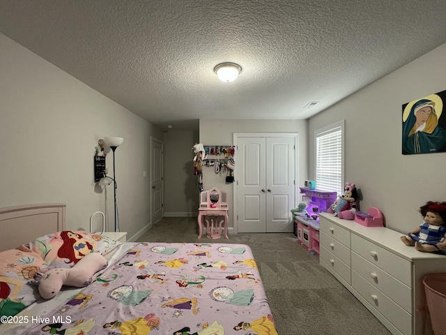 bedroom featuring carpet floors, a closet, visible vents, and a textured ceiling