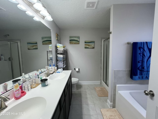 bathroom featuring a shower stall, tile patterned flooring, and a sink