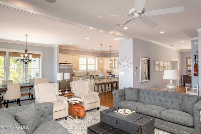 living room featuring crown molding, ceiling fan with notable chandelier, recessed lighting, and light wood-style flooring