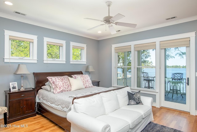 bedroom featuring access to outside, visible vents, multiple windows, and light wood-type flooring