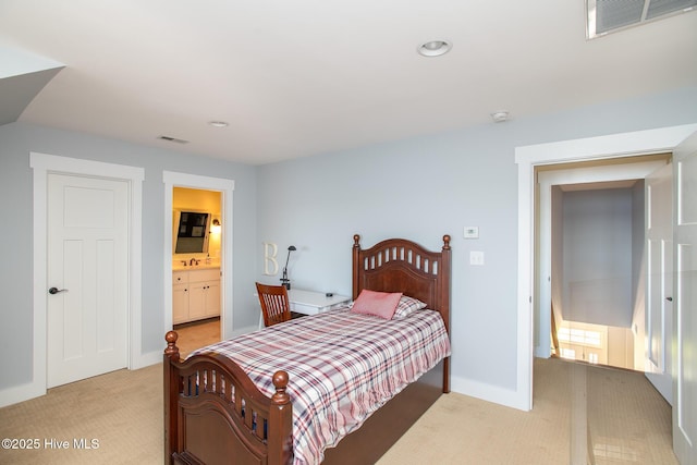 bedroom featuring light colored carpet, recessed lighting, a sink, and visible vents