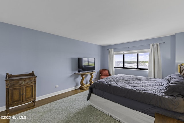 322 Causeway Dr Ste 1001, Wrightsville Beach, NC 28480 - bedroom with baseboards and wood finished floors